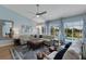Cozy living room featuring shiplap walls, ample seating, and views of the pool at 4120 51St W Dr, Bradenton, FL 34210