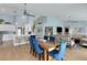 Open-concept living space with a dining table, modern kitchen, and comfortable living room with water views at 4120 51St W Dr, Bradenton, FL 34210