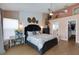 Stylish main bedroom with accent wall, ceiling fan, desk area and an en-suite bathroom at 4120 51St W Dr, Bradenton, FL 34210