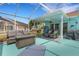 A covered patio features wicker seating, fire pit, grill, and ceiling fan at 4120 51St W Dr, Bradenton, FL 34210