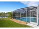The screened pool area features lounge chairs, patio furniture, and relaxing water views at 4120 51St W Dr, Bradenton, FL 34210