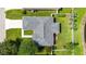Aerial view of the home's roof, landscaping, and proximity to the water at 4194 Banbury Cir, Parrish, FL 34219