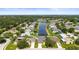 Aerial view showcasing the home's location in a neighborhood with a central lake at 4194 Banbury Cir, Parrish, FL 34219