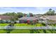 A view of the fenced backyard featuring a small patio and lush green grass at 4194 Banbury Cir, Parrish, FL 34219