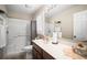 Well-lit bathroom featuring a shower-tub combo, vanity, and a window covered with white plantation shutters at 4194 Banbury Cir, Parrish, FL 34219