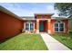 Inviting home entrance featuring arched windows, a vibrant blue door, and decorative potted plants at 4194 Banbury Cir, Parrish, FL 34219