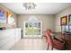 Bright home office featuring built-in storage and a desk, with a large window covered by white plantation shutters at 4194 Banbury Cir, Parrish, FL 34219