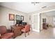 Inviting home office space with a wooden desk and chair, adjacent to another room visible through a glass-paneled door at 4194 Banbury Cir, Parrish, FL 34219