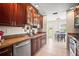 Well-lit kitchen features stainless appliances, granite countertops, and wood cabinets at 4194 Banbury Cir, Parrish, FL 34219