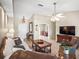 Inviting living room with tile floors, chandelier, and comfortable seating arrangement at 4194 Banbury Cir, Parrish, FL 34219