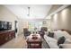 Well-lit living room showcases tile floors, fan, and picturesque outdoor views at 4194 Banbury Cir, Parrish, FL 34219