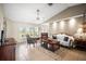 Spacious living room is well-lit with tile floors, ceiling fan, and stylish furnishings at 4194 Banbury Cir, Parrish, FL 34219