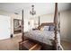 Spacious bedroom features a four-poster bed with decorative pillows, a side table, and access to an ensuite bathroom at 4194 Banbury Cir, Parrish, FL 34219