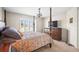 Bedroom featuring a four-poster bed, dresser, a decorative chandelier, and plantation-shuttered windows at 4194 Banbury Cir, Parrish, FL 34219