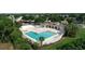 Aerial view of community pool, showcasing amenities, lush landscaping, and inviting lounge areas at 4194 Banbury Cir, Parrish, FL 34219