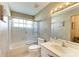 Standard bathroom features a tub with shower, toilet, and vanity with large mirror at 4227 Placid Dr, Sarasota, FL 34243