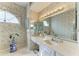 Bright bathroom features a dual sink vanity, large mirror, and decorative accents at 4227 Placid Dr, Sarasota, FL 34243
