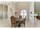 Cozy dining area with a round table, decorative chairs, and natural light from a window at 4227 Placid Dr, Sarasota, FL 34243