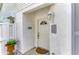 Welcoming front entryway with a classic white door and decorative outdoor lighting at 4227 Placid Dr, Sarasota, FL 34243