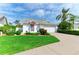 Inviting home with lush green lawn, mature palms, and a convenient two-car garage at 4227 Placid Dr, Sarasota, FL 34243