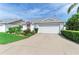 Beautiful one-story home featuring a well-kept lawn, mature plantings, and a two-car garage at 4227 Placid Dr, Sarasota, FL 34243