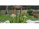 Wooden gazebo designated as a smoking area surrounded by beautiful shrubs and bushes in a green area at 4227 Placid Dr, Sarasota, FL 34243