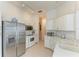 Clean, white kitchen with modern appliances, ample counter space, and an adjacent dining area at 4227 Placid Dr, Sarasota, FL 34243