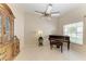 Open-concept living area with tile flooring, ceiling fan, and view of the garden through a large window at 4227 Placid Dr, Sarasota, FL 34243