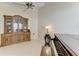 Open-concept living area with tile flooring, ceiling fan, vintage cabinet and grand piano at 4227 Placid Dr, Sarasota, FL 34243