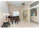 Open-concept living area with tile flooring, ceiling fan, and a view through a large window at 4227 Placid Dr, Sarasota, FL 34243