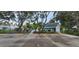 Community parking lot with clearly marked spaces and a fenced entrance to a clubhouse at 4227 Placid Dr, Sarasota, FL 34243