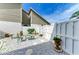 Private patio area with white rock, stone pavers, and a cozy outdoor seating area at 4227 Placid Dr, Sarasota, FL 34243