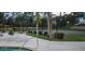 Relaxing pool area featuring lounge chairs, vibrant flowers, and a view of the tennis court at 4227 Placid Dr, Sarasota, FL 34243