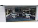 Relaxing pool cabana area featuring tables, chairs, ceiling fans, and an outdoor bar for easy access at 4227 Placid Dr, Sarasota, FL 34243