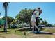 A statue of a sailor kissing a nurse set in a park with parked cars and greenery on a sunny day at 4227 Placid Dr, Sarasota, FL 34243