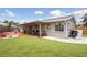 Spacious backyard featuring a covered patio and a lush green lawn at 4303 83Rd W St, Bradenton, FL 34209