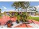 Lush backyard oasis featuring tropical plants, a patio set, and pristine landscaping at 4303 83Rd W St, Bradenton, FL 34209
