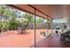 Covered patio and open patio backyard space with seating and lush tropical landscaping at 4303 83Rd W St, Bradenton, FL 34209
