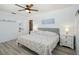 Charming bedroom with hardwood flooring, decorative headboard and coastal-themed accents at 4303 83Rd W St, Bradenton, FL 34209