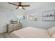 Bedroom showcasing a ceiling fan, a window with blinds, and a light-colored dresser with mounted television at 4303 83Rd W St, Bradenton, FL 34209