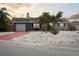 Inviting single-story home with a colorful red driveway and rock landscaping, captured at twilight at 4303 83Rd W St, Bradenton, FL 34209