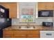 Bright kitchen featuring stainless steel sink with granite countertops and modern appliances at 4303 83Rd W St, Bradenton, FL 34209