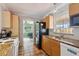 Well-lit kitchen with stainless steel appliances, granite countertops and access to the lanai at 4303 83Rd W St, Bradenton, FL 34209