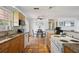Open-concept kitchen with tile flooring, granite countertops and views of the dining area at 4303 83Rd W St, Bradenton, FL 34209