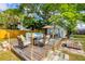 Relaxing backyard patio with outdoor seating, umbrella, hot tub, and tiki torches at 4528 58Th W St, Bradenton, FL 34210