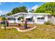 Charming single-story home featuring awnings, tidy landscaping and decorative rock features on a bright, sunny day at 4528 58Th W St, Bradenton, FL 34210