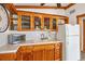 Kitchen featuring wood cabinets, tiled countertops, and practical appliances for efficient cooking at 4528 58Th W St, Bradenton, FL 34210