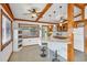 Eat-in kitchen with exposed wood beams, white cabinets, and a peninsula island with barstool seating at 4528 58Th W St, Bradenton, FL 34210