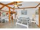 Open-concept living area with terrazzo floors and exposed beams connected to the kitchen and dining areas at 4528 58Th W St, Bradenton, FL 34210