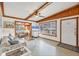 Bright living room with terrazzo floors, exposed wood beams, and a large window with natural light at 4528 58Th W St, Bradenton, FL 34210